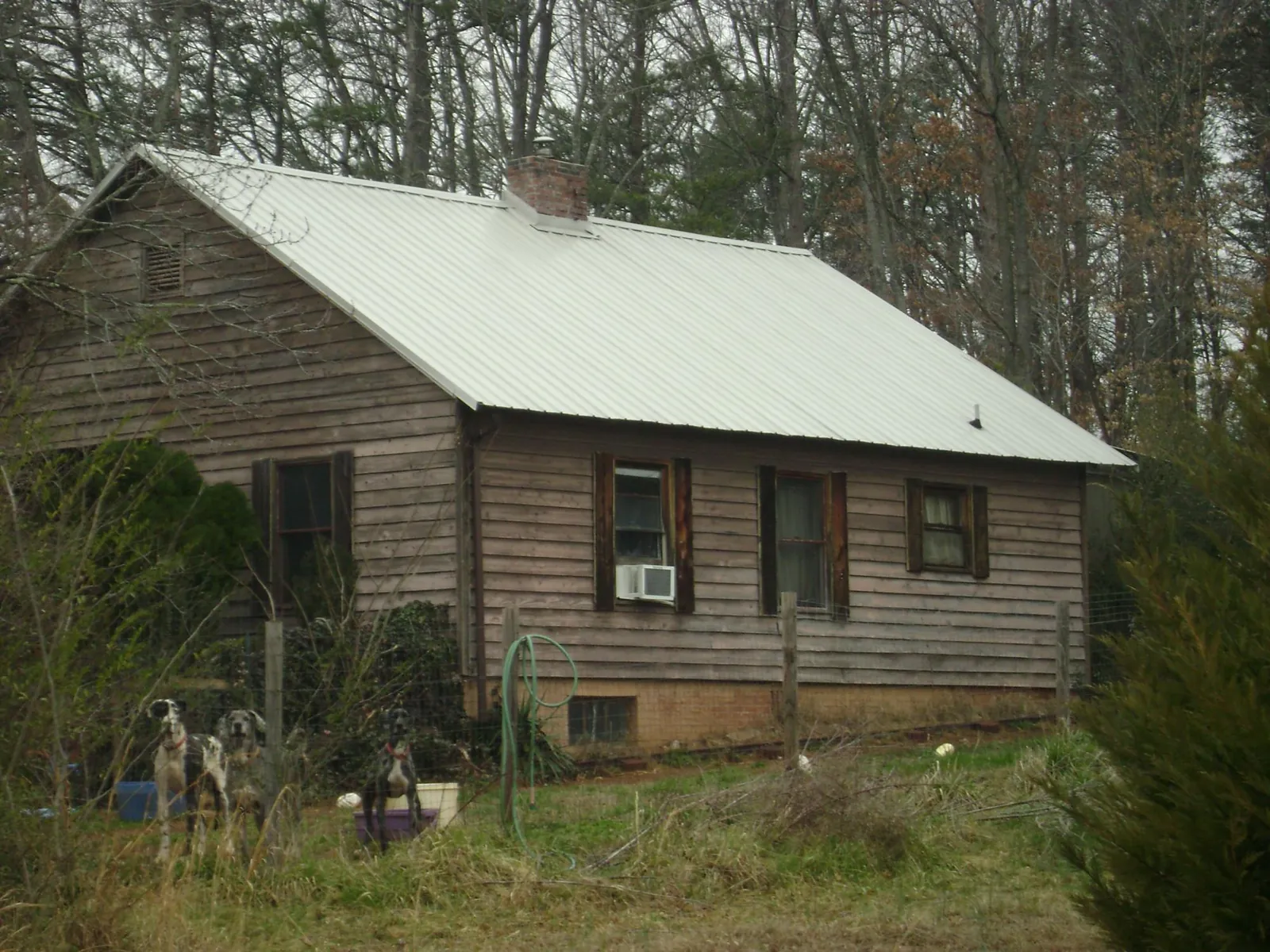 White metal roof on an old wood sided farmhouse, from a Metal Roof Installation job in Gillette